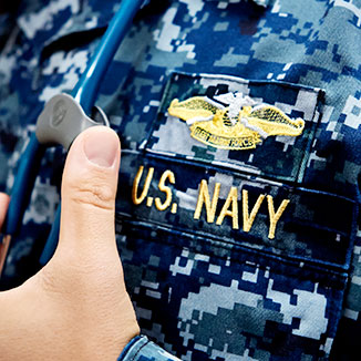 A military physician in a U.S. Navy uniform. A military physician in a U.S. Navy uniform.