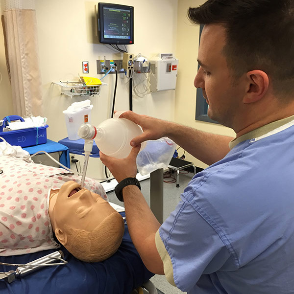 John intubates a simulation mannequin 