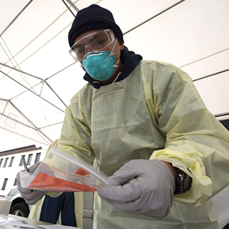 Medical technician handles supplies in the Ramstein Medical Clinic’s Coronavirus disease 2019 screening drive-thru at Ramstein Air Base.