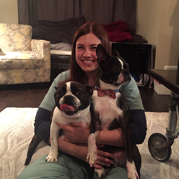 Sara hugging her two dogs