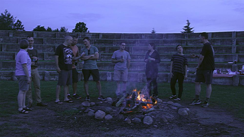 Sara and her friends standing in front of a fire