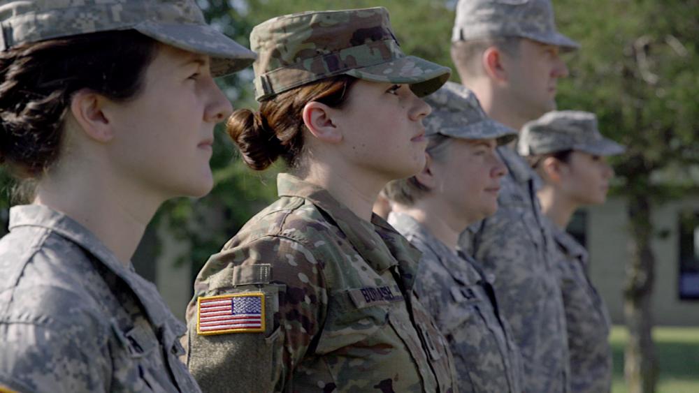 Sara wearing her military uniform standing in formation.