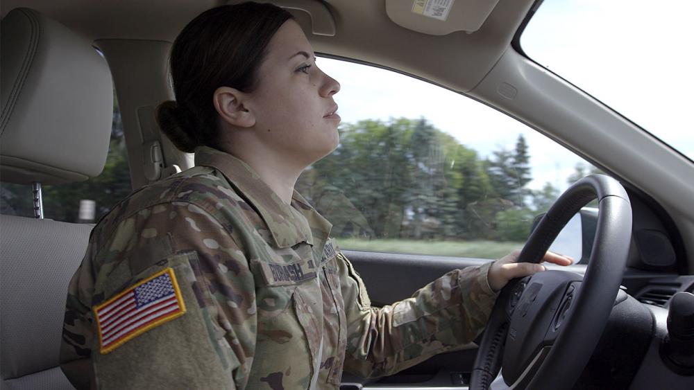 Sara in car driving.