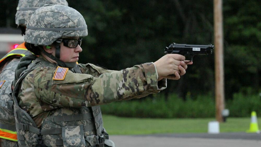 Sara pointing a gun toward a target