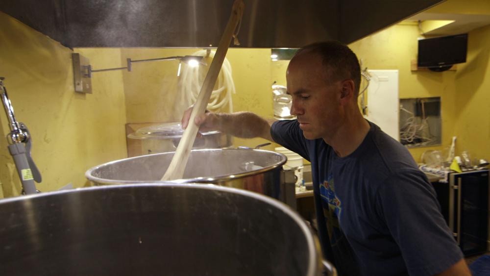 Forsberg looking stirring a beer kettle 