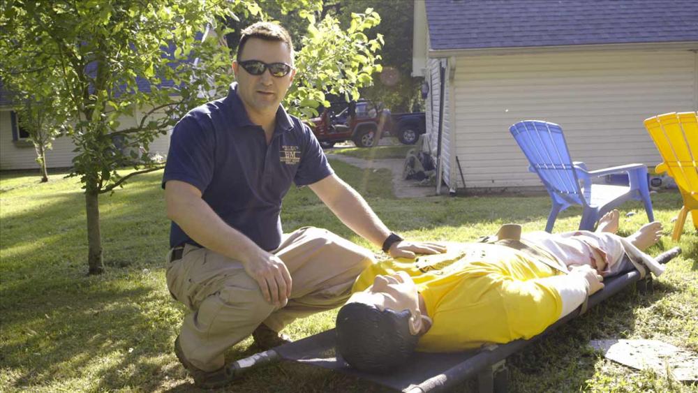 John sitting next to a patient simulator 