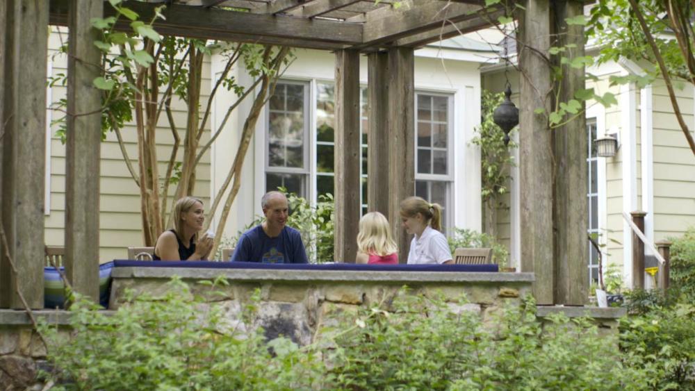 The Forsberg family eating dinner on outdoor patio 