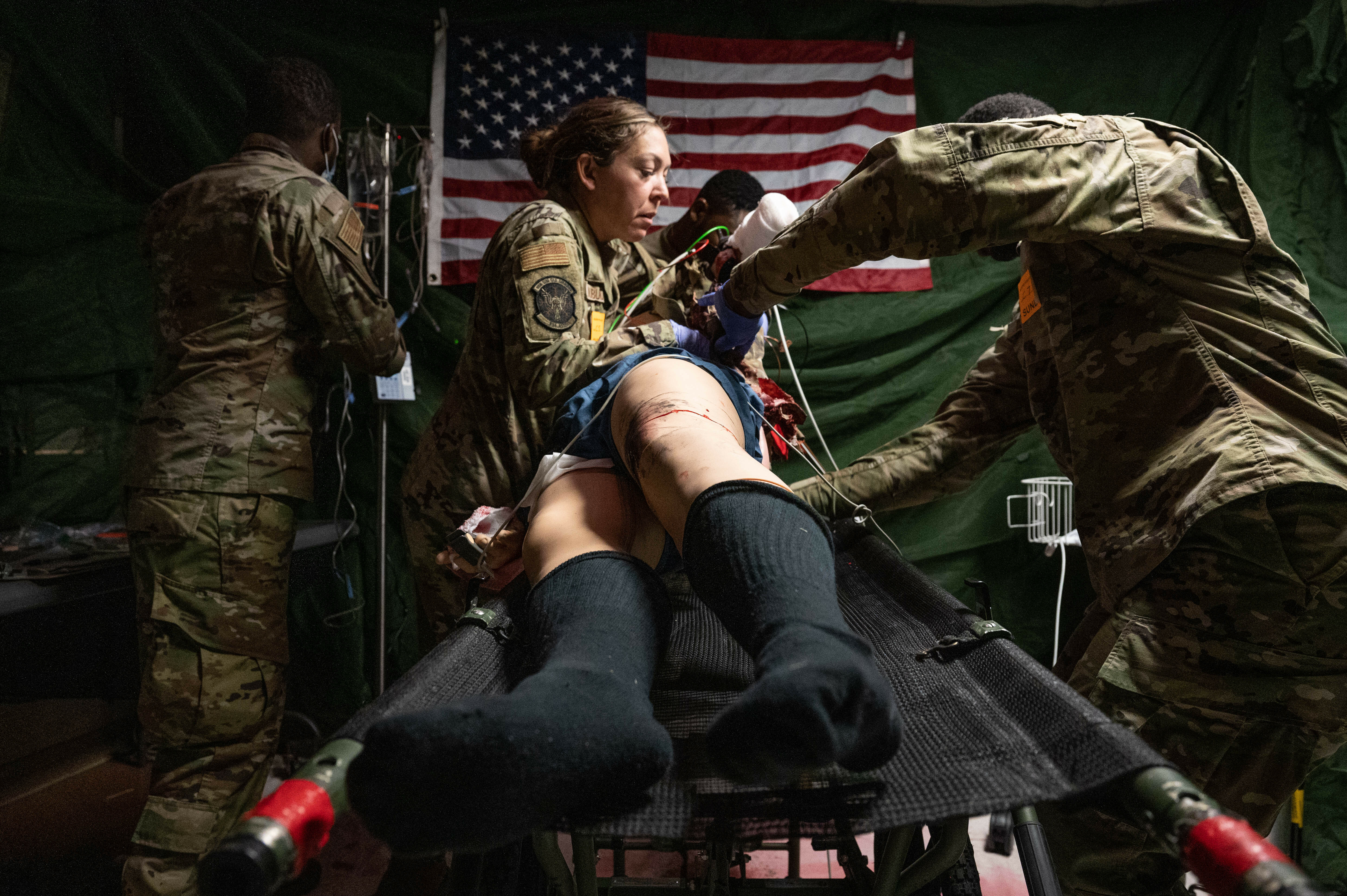 Airmen from the 934th Aeromedical Staging Squadron turn a mannequin over during a training exercise 