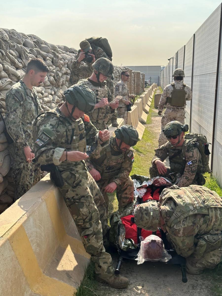 230224-N-N1526-0001 Erbil Air Base, Iraq (Feb. 24, 2023) - Hospital Corpsman 1st Class Joshua Thomas, left, monitors coalition force members as the treat a simulated casualty during the Inaugural Mass Casualty Olympics on Feb. 24, 2023.